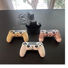 3 PS4 controllers and a charging dock. 