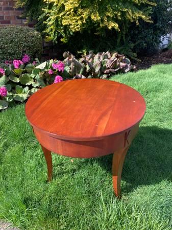 round solid wood side table with curved legs and carved detail