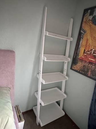 Matching white ladder bookcases