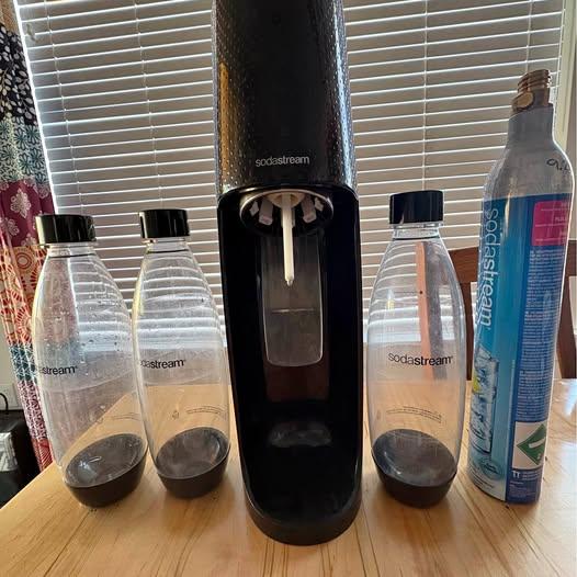 SodaStream machine with bottles and CO2 canisters