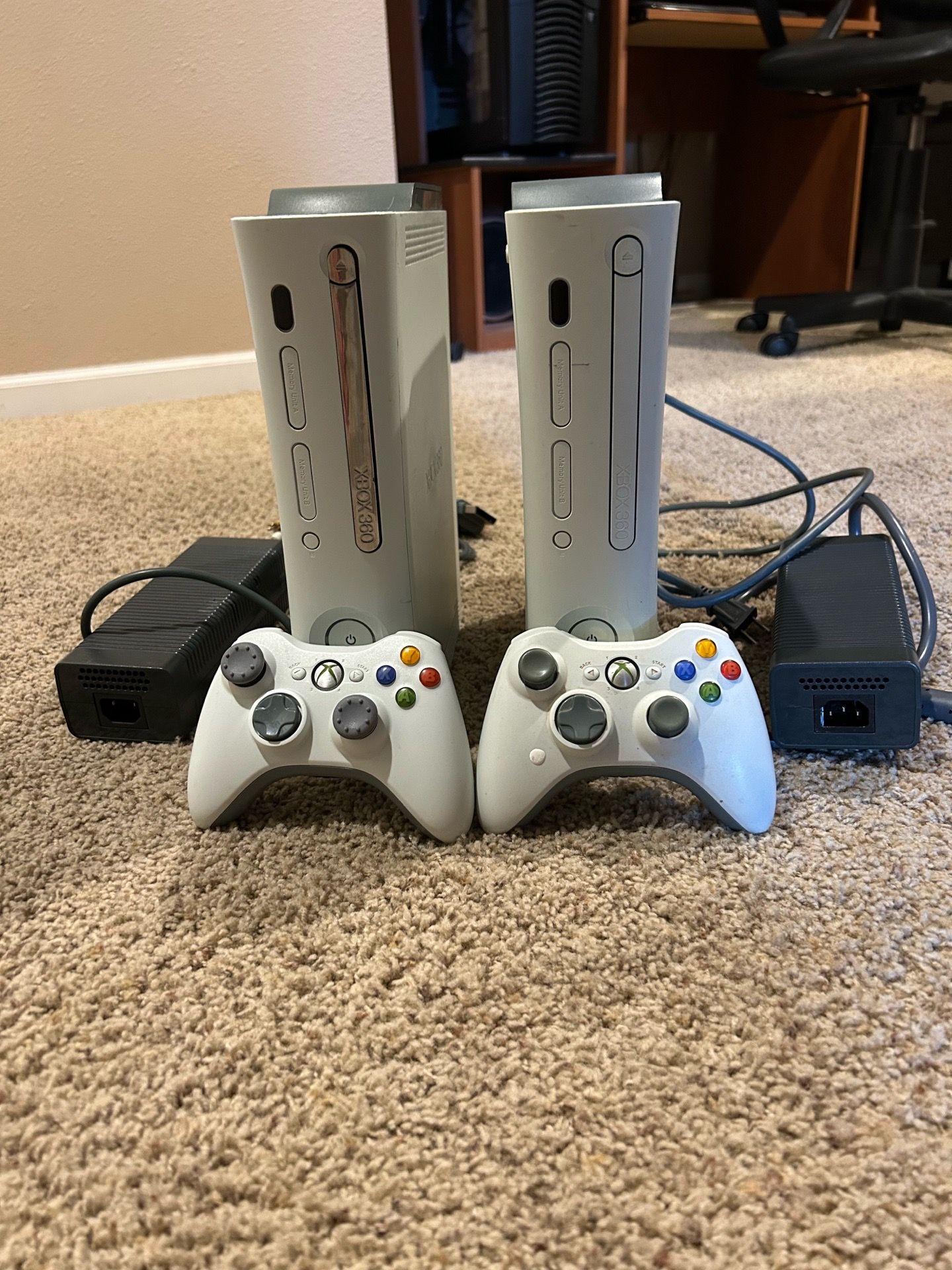 2 XBOX 360 gaming consoles and controllers.